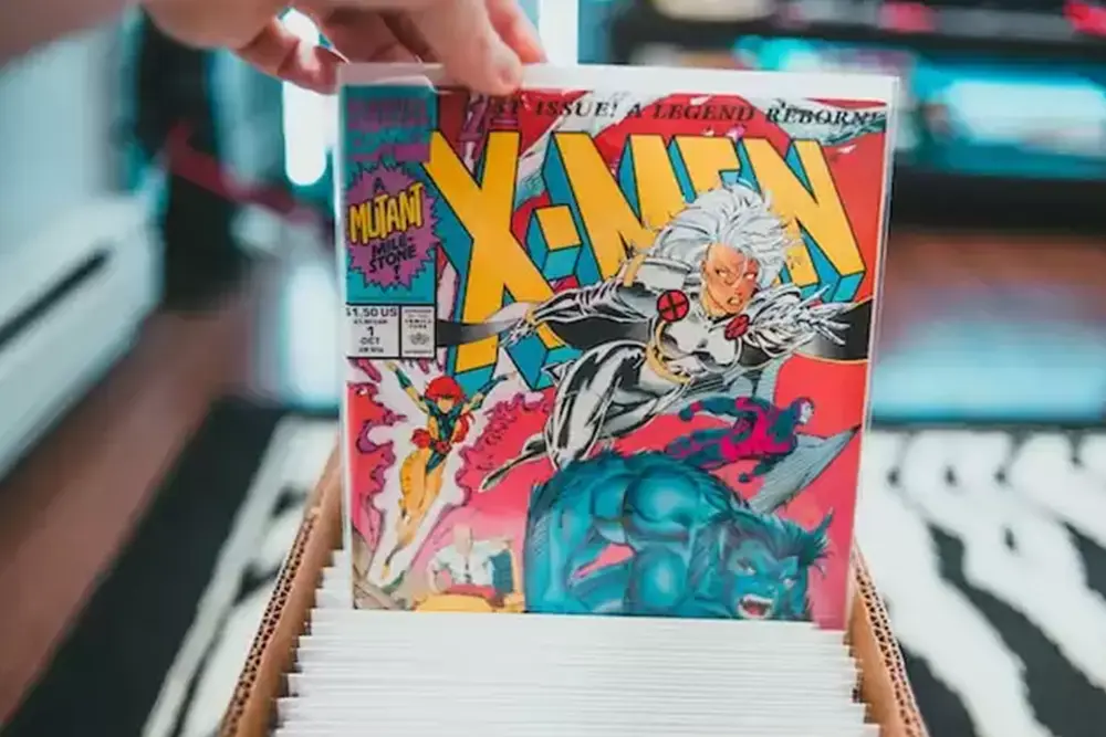 person in comic book store browsing through a box of Marvel comic books
